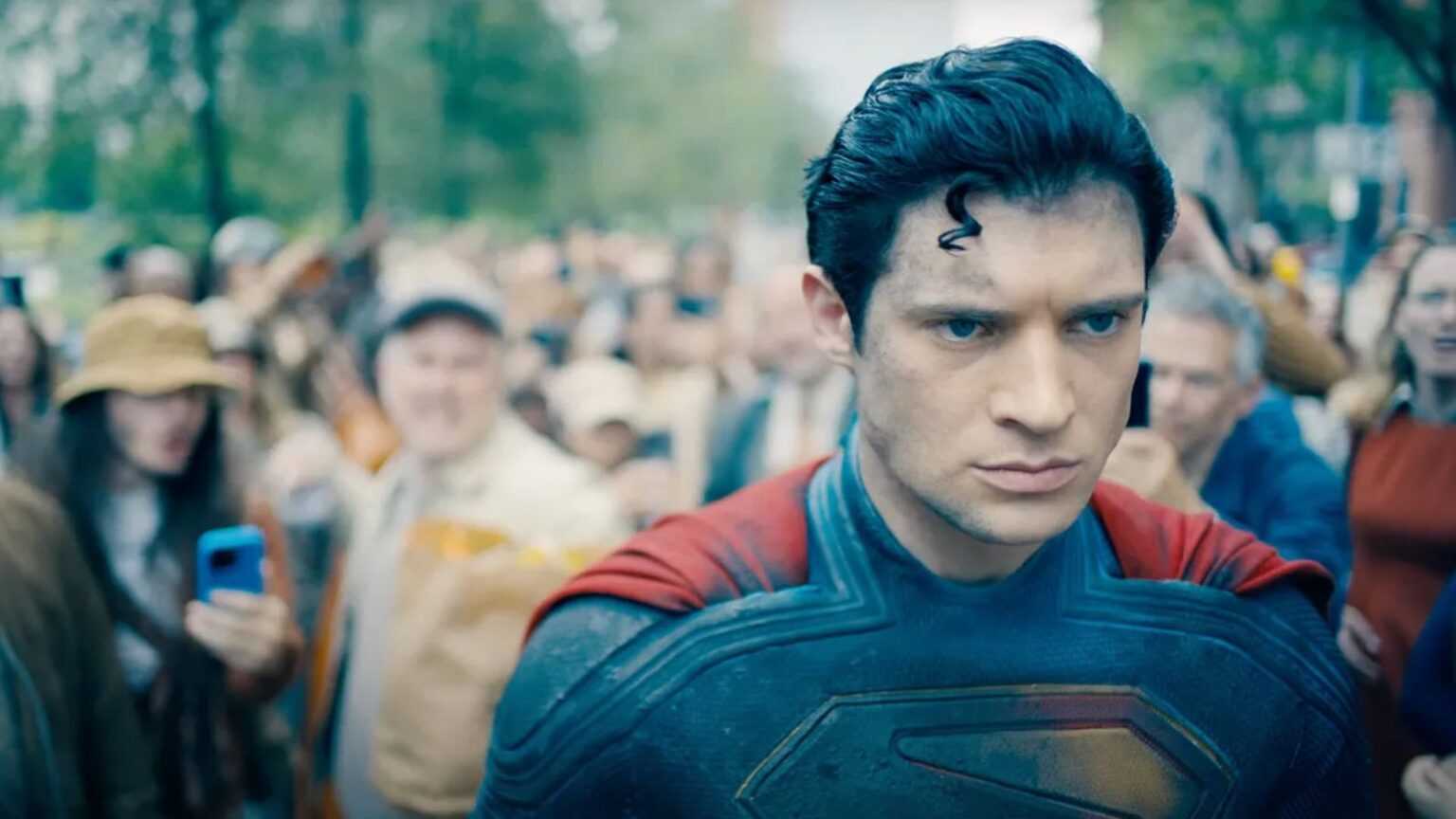 Superman idzie przez tłum. Ludzie go nienawidzą i obrzucają przedmiotami.